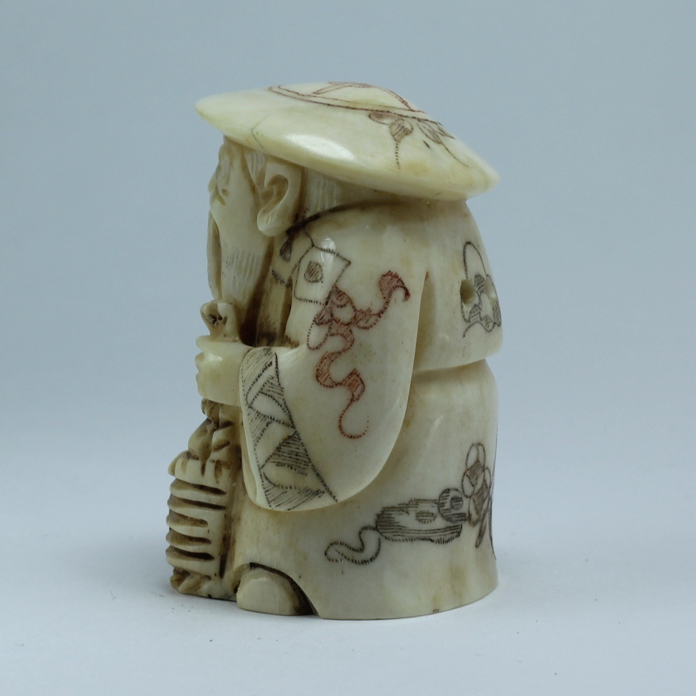 Нэцкэ Дзюроднин в круглой шапке с корзиной рыбы