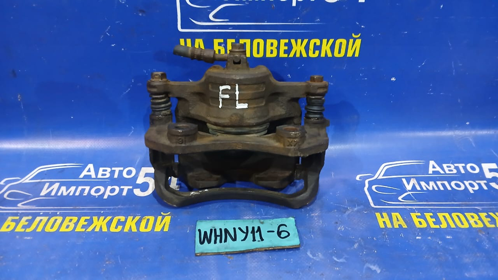 Суппорт тормозной передний левый NISSAN WINGROAD 1999