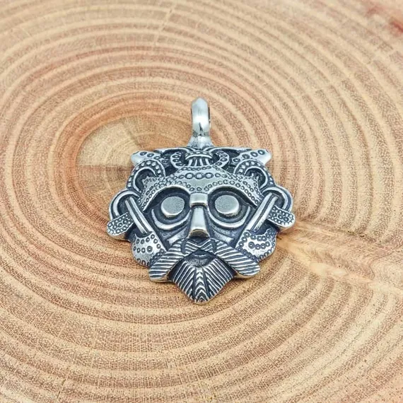 Изображение маска Одина на деревянном срезе.