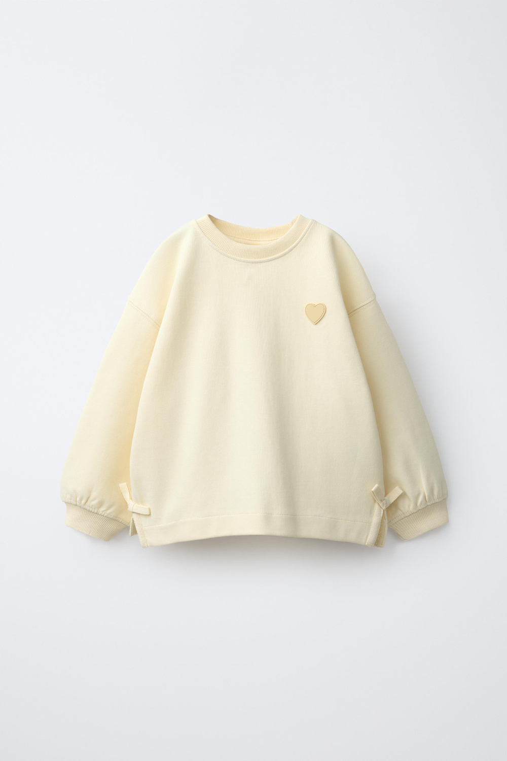 ZARA ТОЛСТОВКА С БАНТАМИ И СЕРДЦЕМ, ЦВЕТ СЛИВОЧНОГО МАСЛА