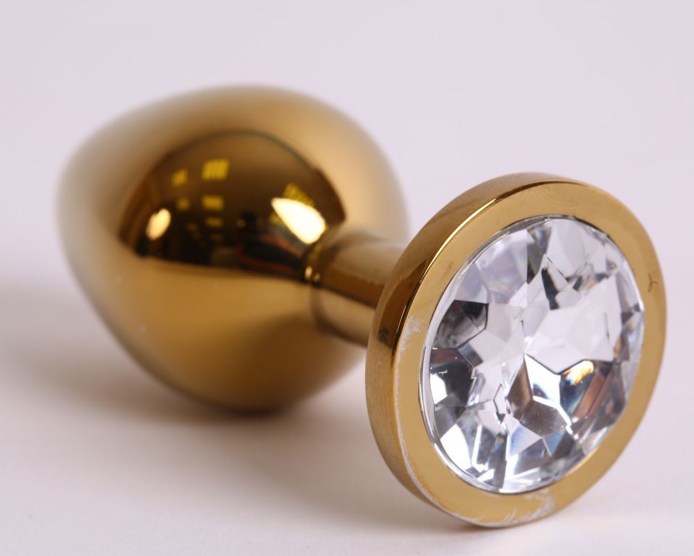 Золотистая анальная пробка с прозрачным кристаллом - 8,2 см.