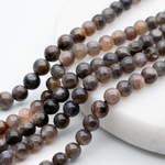 Солнечный камень темный бусины, диаметр около 5,5-5,9 мм, цена за 16-17 шт (1/4 нити)