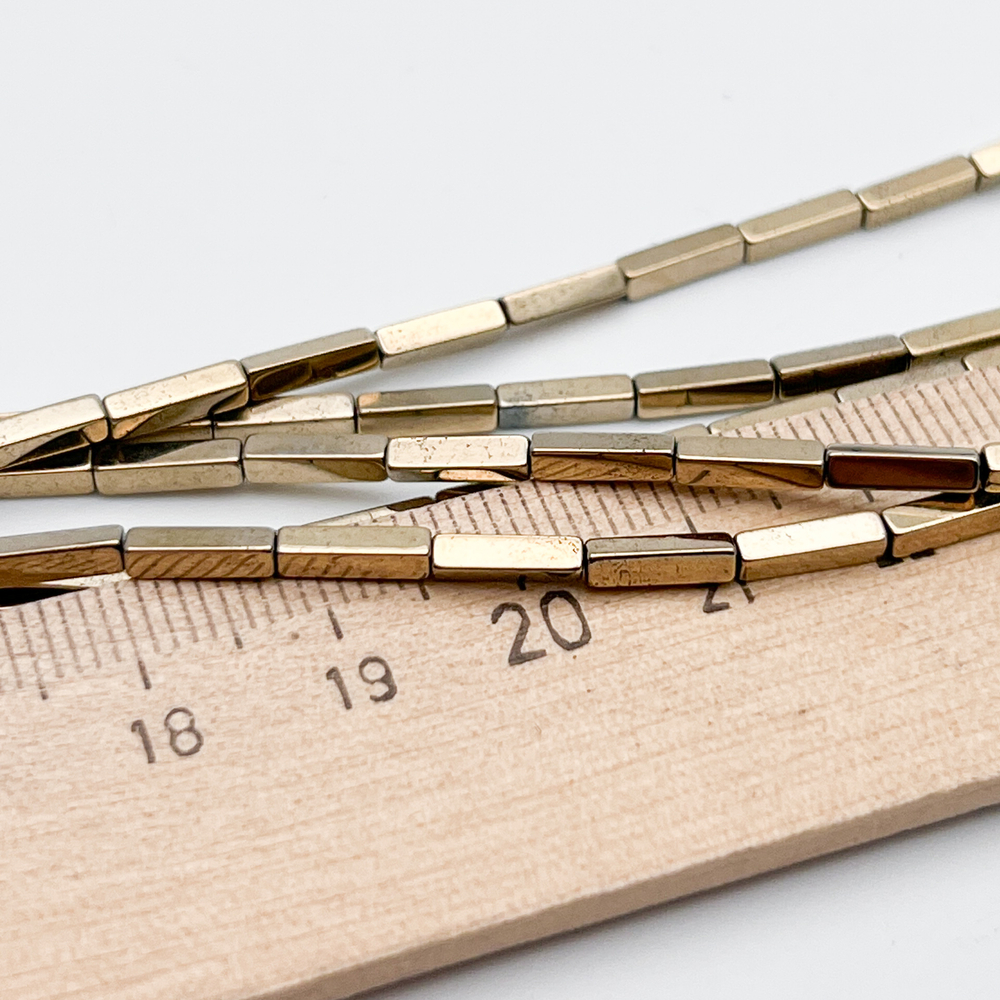 Гематит Брусок бусины (имитация), цвет золотистый, размер около 8*2 мм, цена за 22-23 шт (1/2 нити)